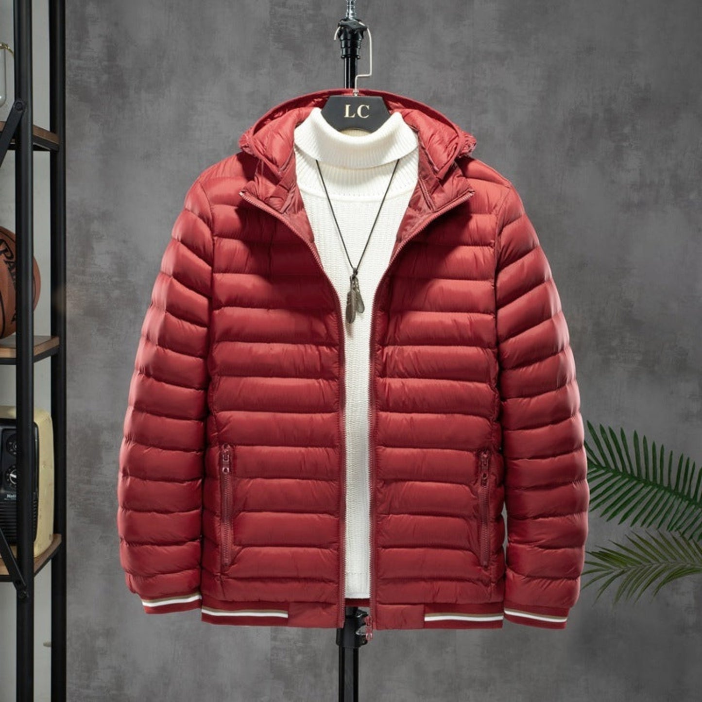 Bright red men's cotton-padded jacket with detachable hood and white interior, displayed on a hanger.