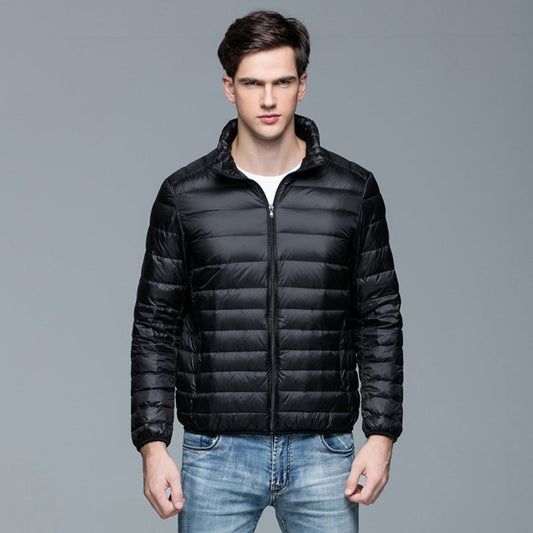 Front view of a black lightweight puffer jacket, modeled with a zipped-up design.