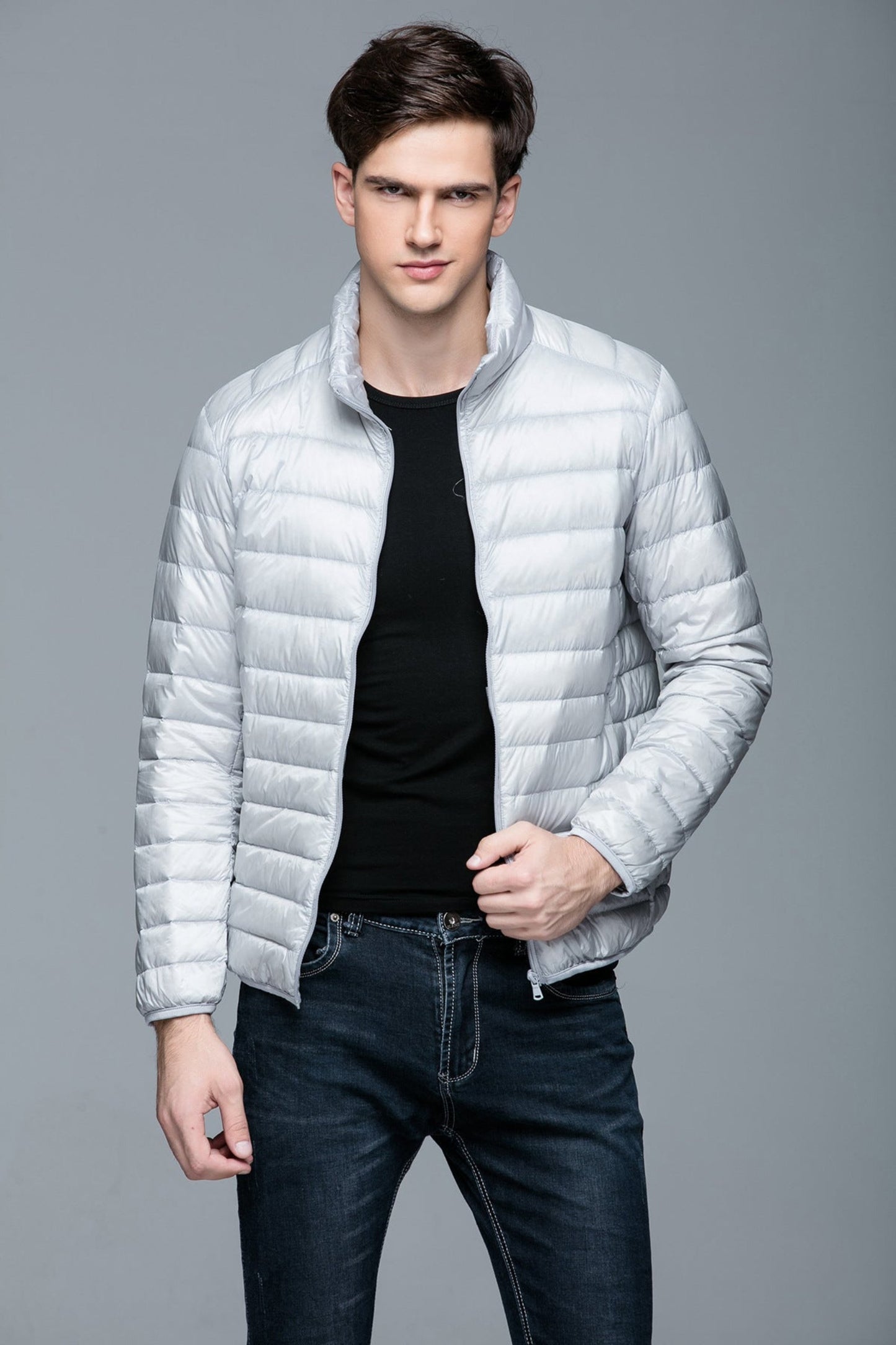 Front view of a grey lightweight puffer jacket, modeled for a minimalist winter look.