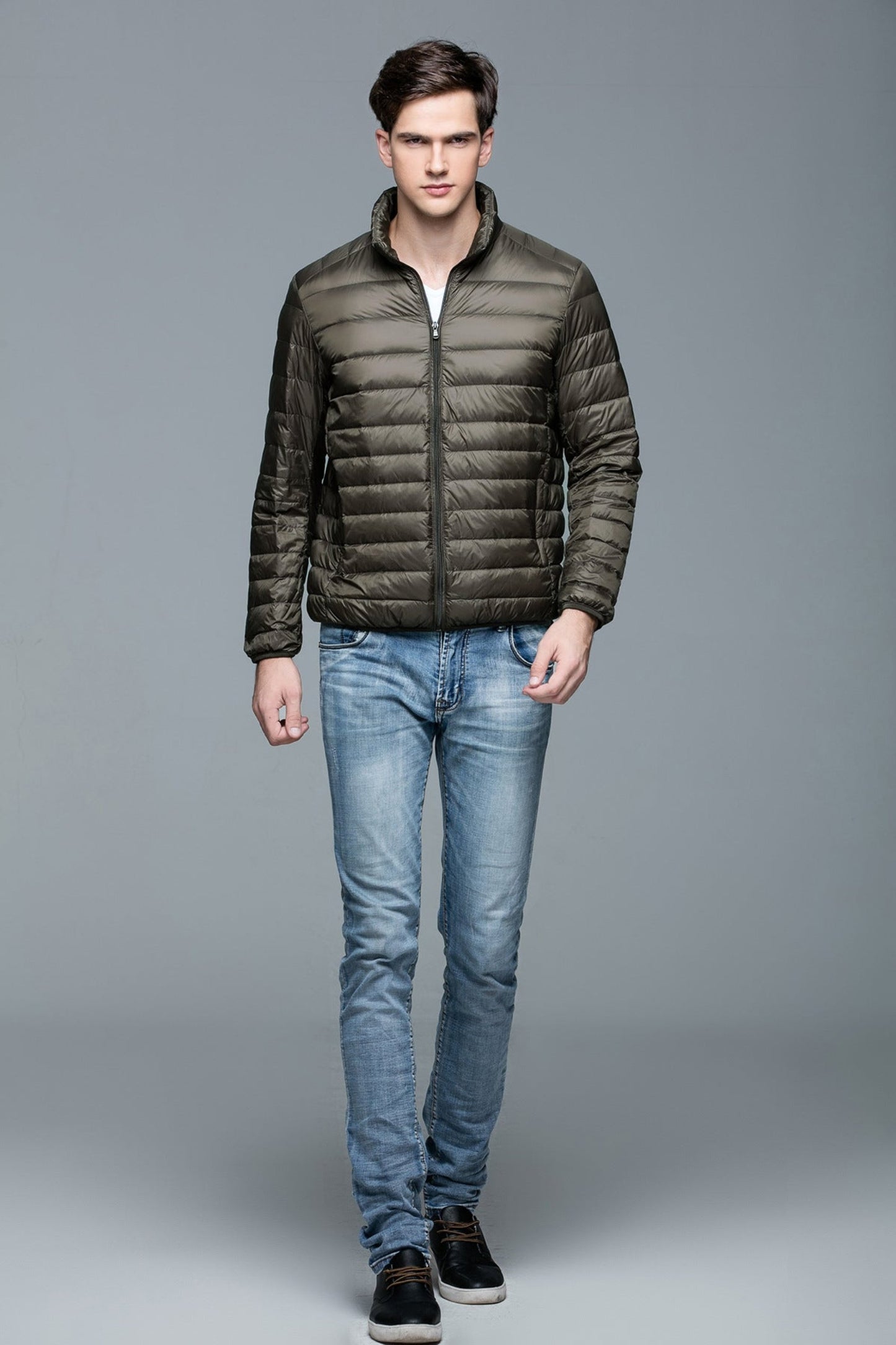 Front view of an army-green lightweight puffer jacket, modeled with a neutral style.