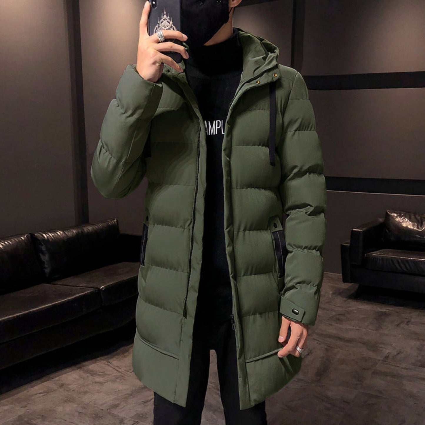 A solo front view of the army green puffer jacket styled indoors, highlighting its sleek design.