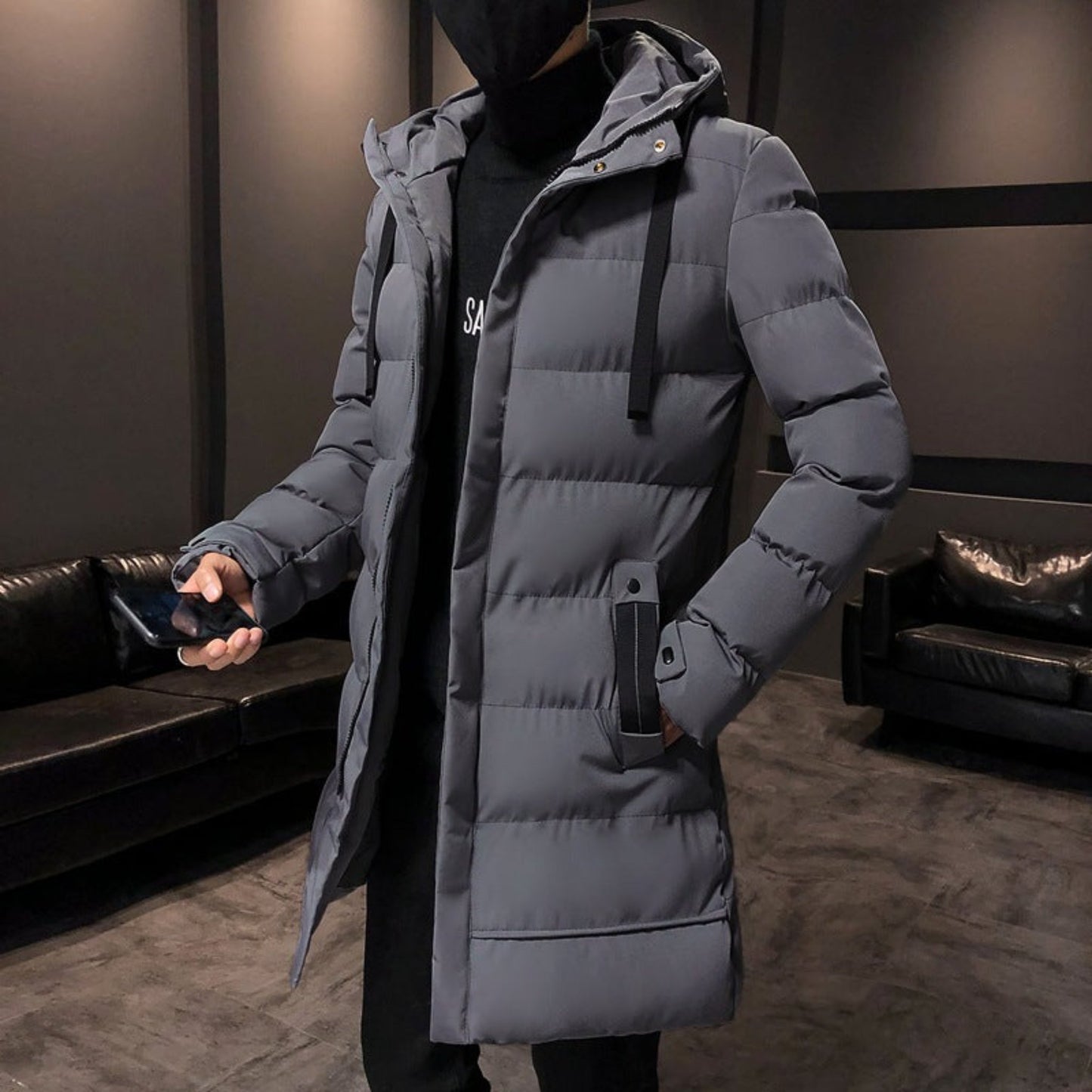 Full-length view of the gray puffer jacket worn in a casual setting, emphasizing the mid-length cut.