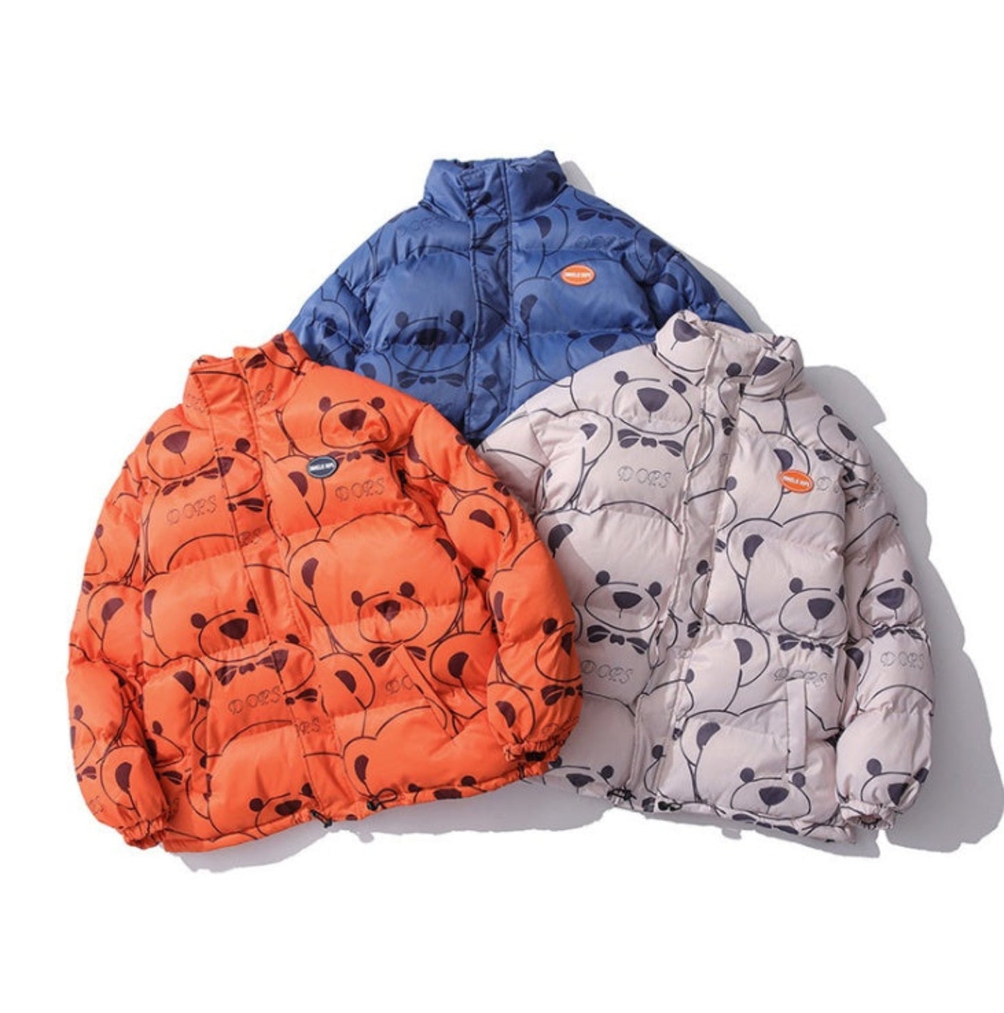 Set of Three Bear Pattern Puffer Jackets - Orange, Blue, and Lotus Pink Root Displayed Together