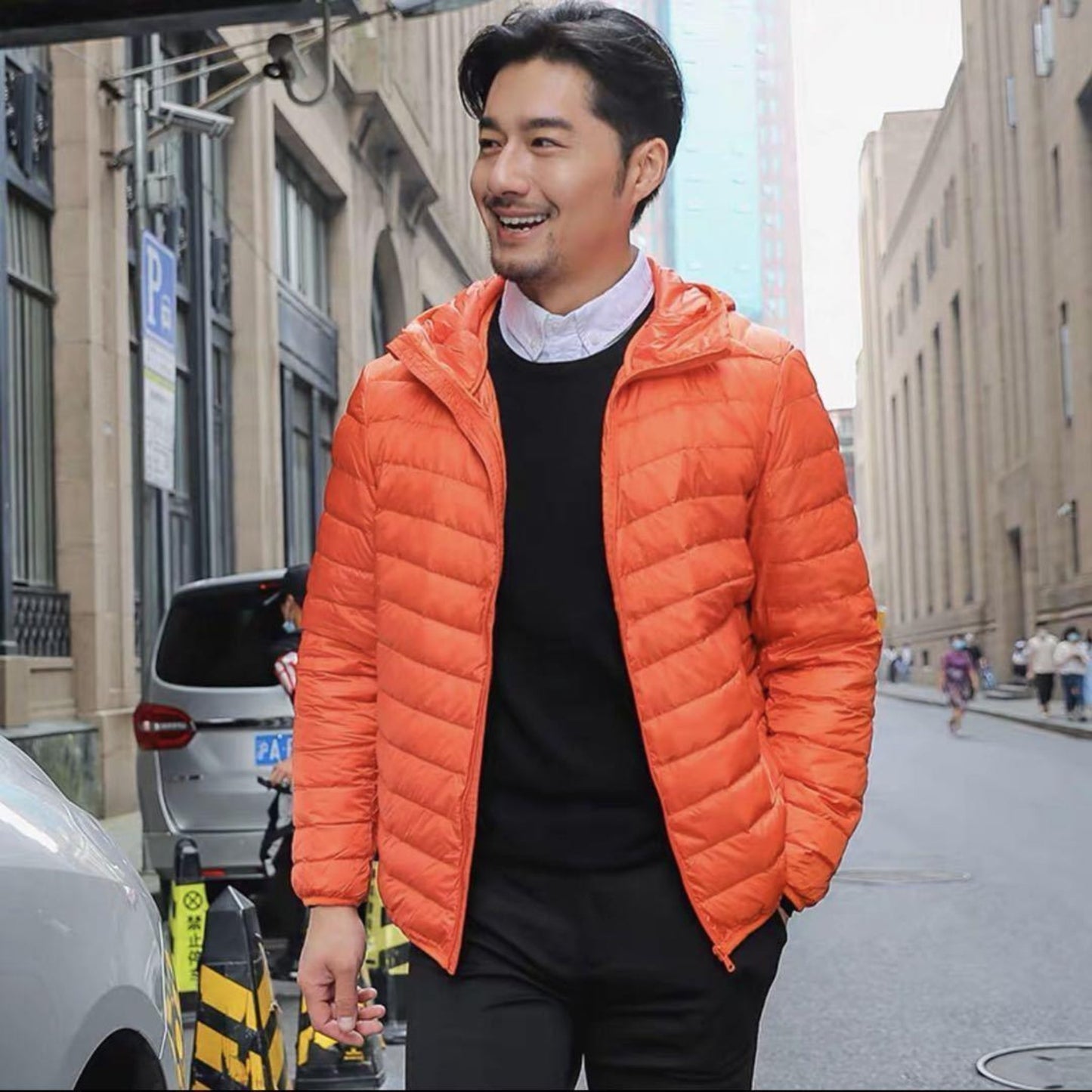 Bright orange men's down jacket with a relaxed fit, perfect for vibrant city style.