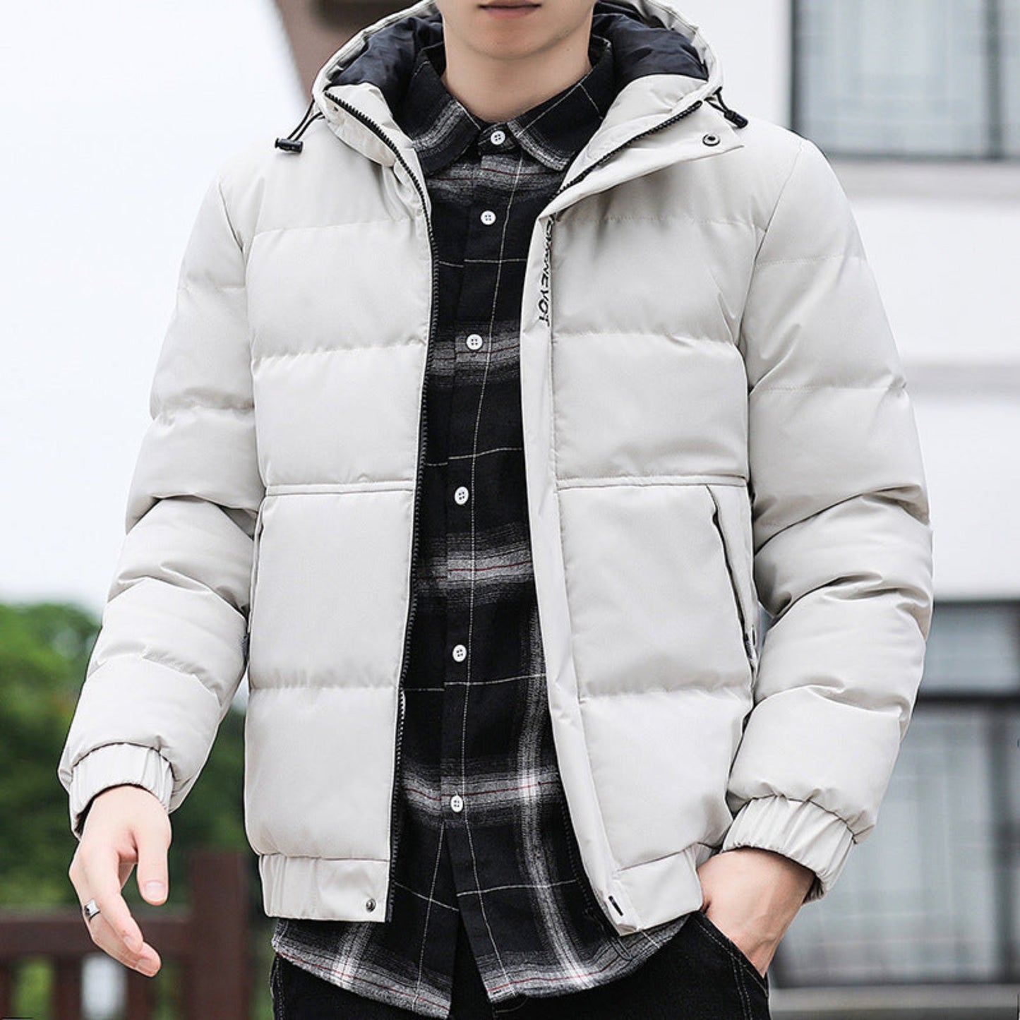 Model wearing the white padded winter jacket, styled with a stand-up collar for a casual outdoor look.