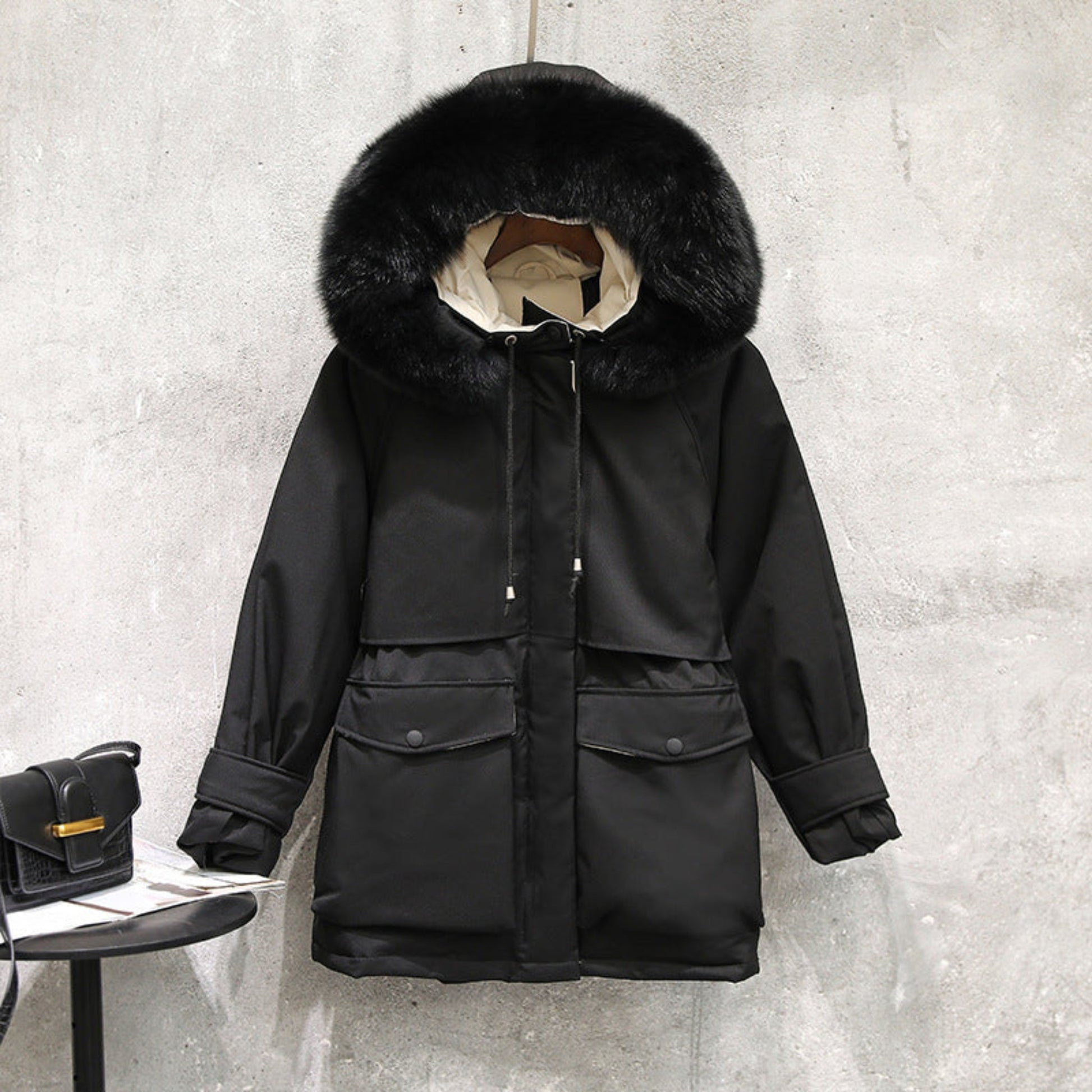 Front view of a women’s black fur-collar winter jacket, featuring a plush fur hood and tailored fit.