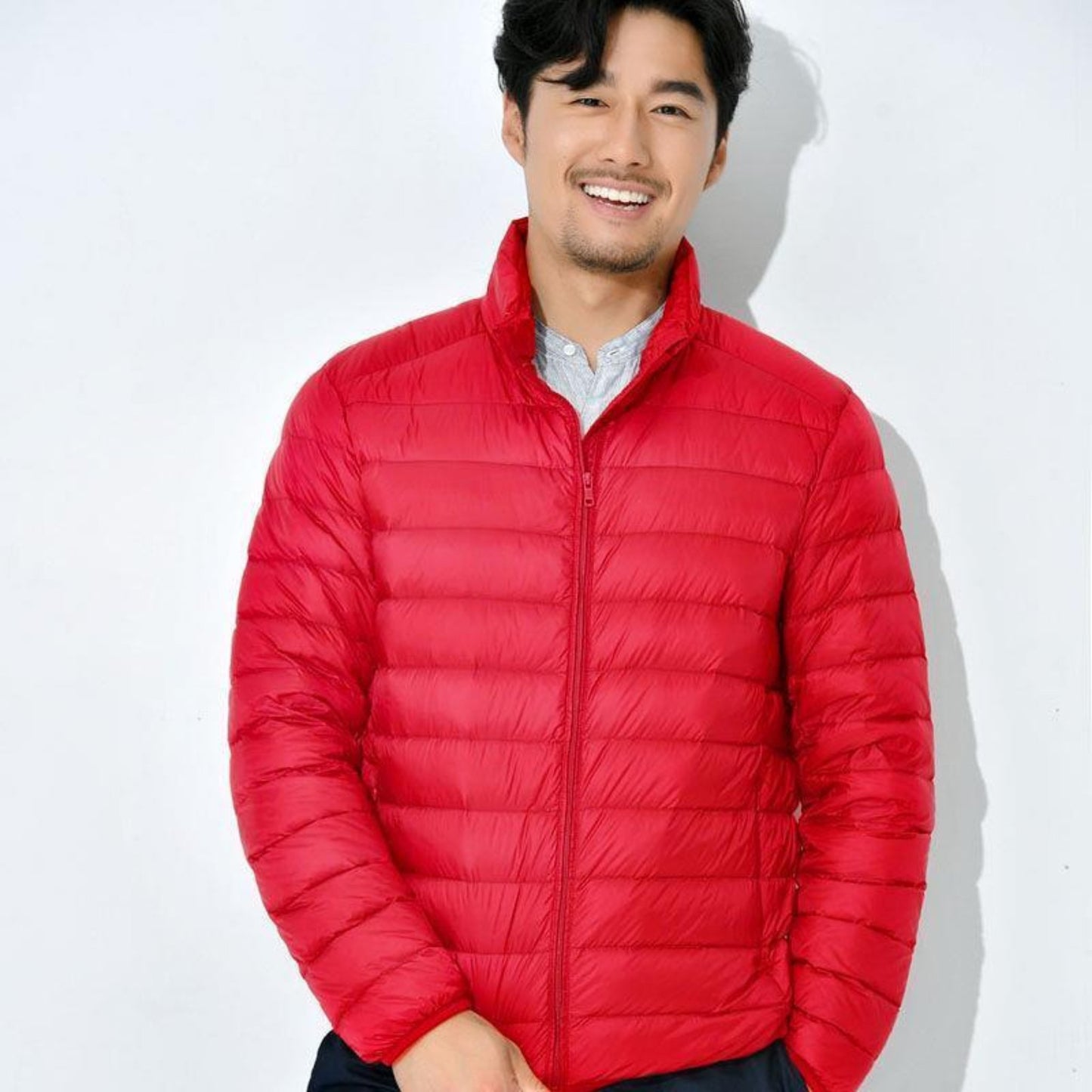 Model featuring the Red lightweight down jacket for winter-ready styling.