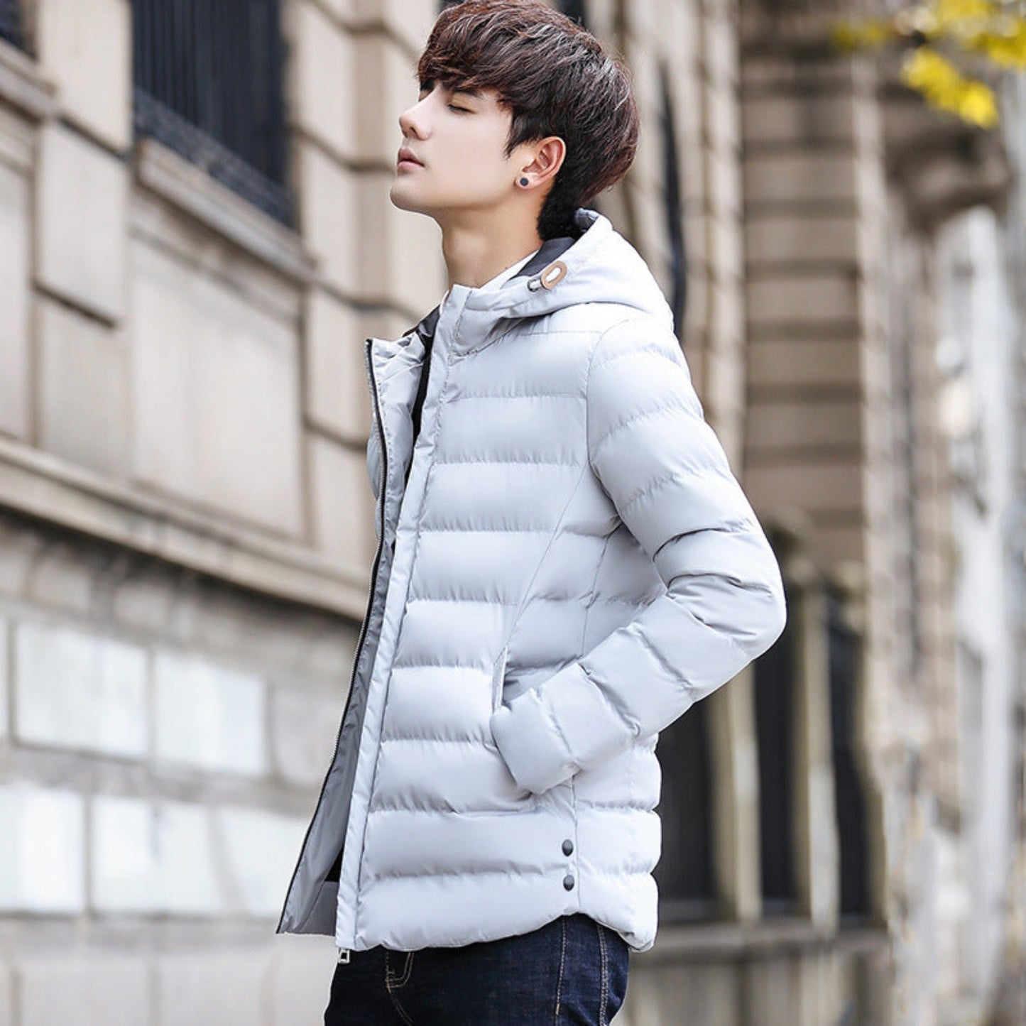 Side view of men's white-grey thickened winter puffer jacket with hood.