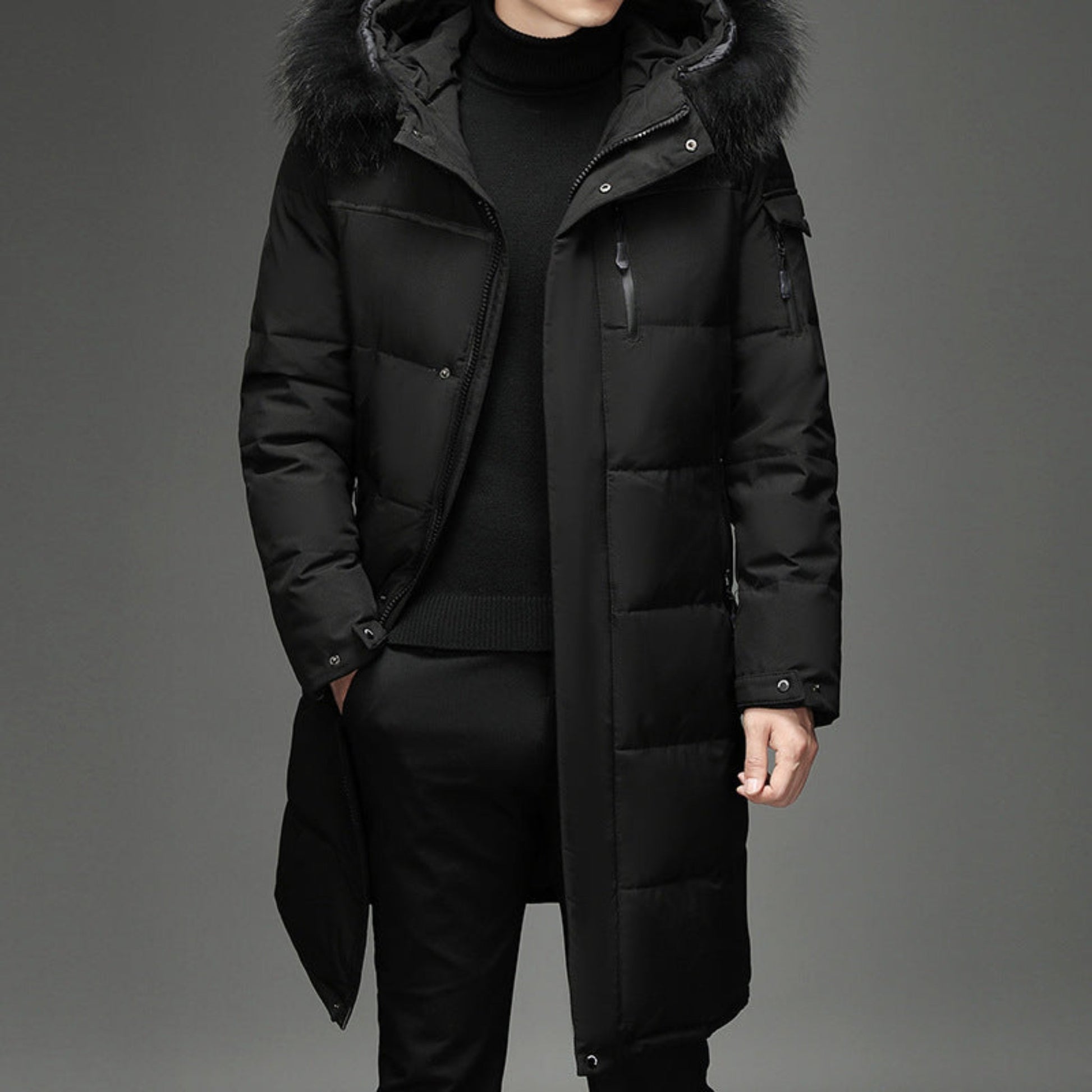 Front view of a black winter coat with faux fur collar, worn by a model.