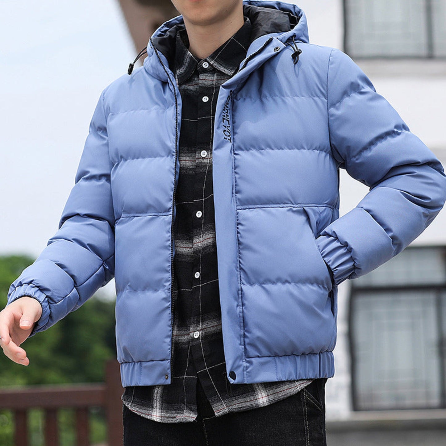 Model wearing the blue padded winter jacket, styled with a casual shirt underneath for a modern look.