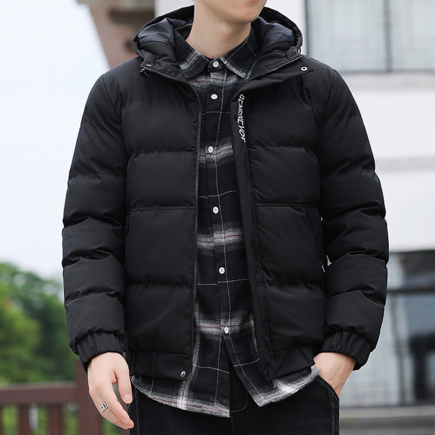 Model wearing the black padded winter jacket with a stand-up collar, styled for cold-weather wear.