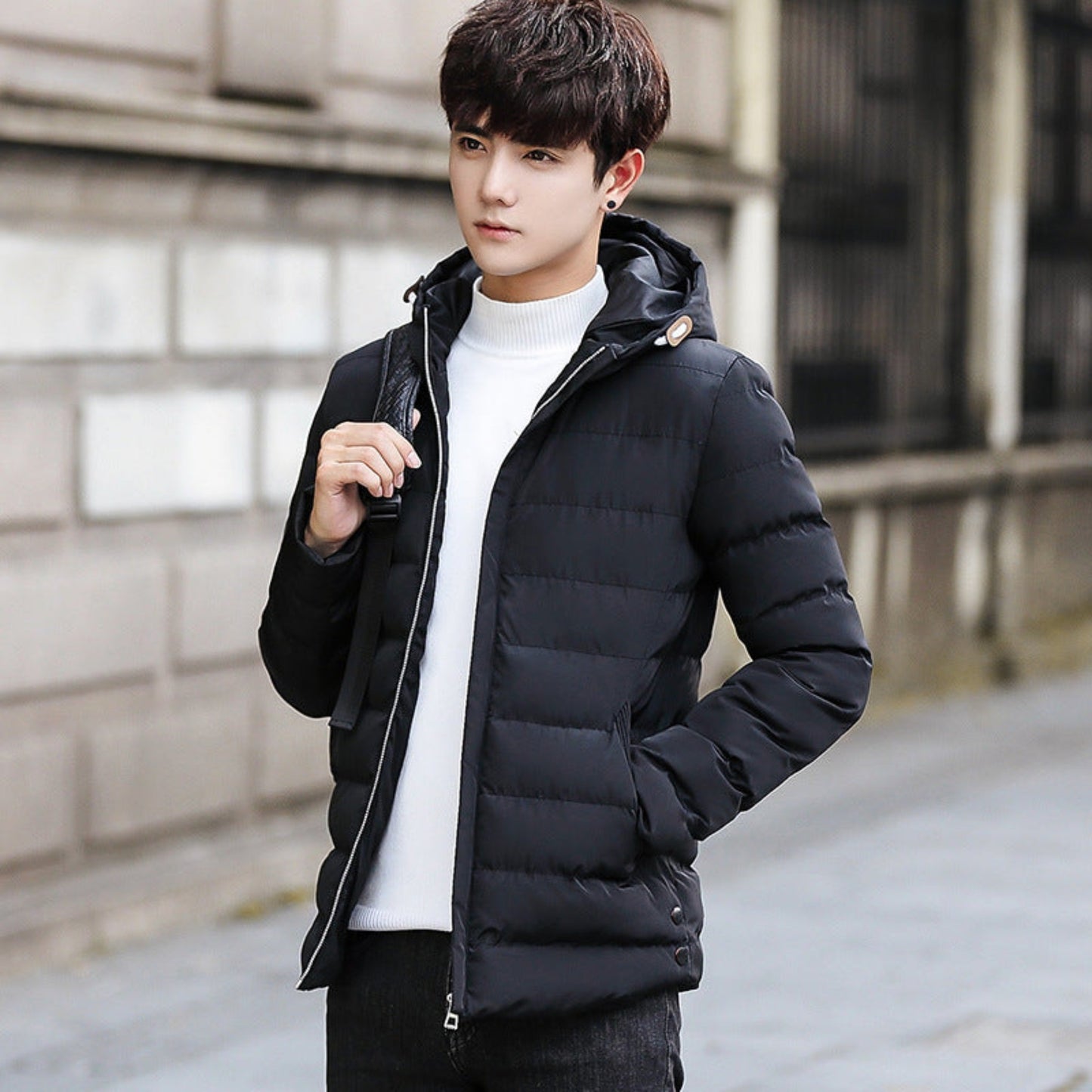 Model wearing a black cotton puffer jacket, paired with casual winterwear.