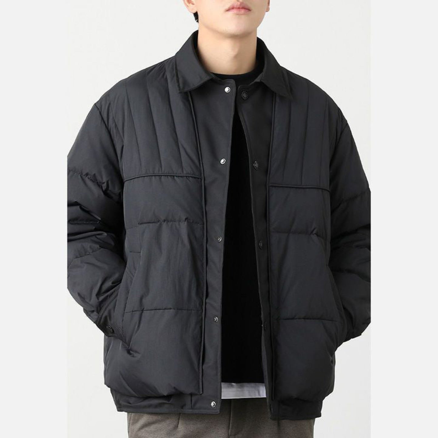 Men's black button-up quilted jacket with lightweight design, front view.