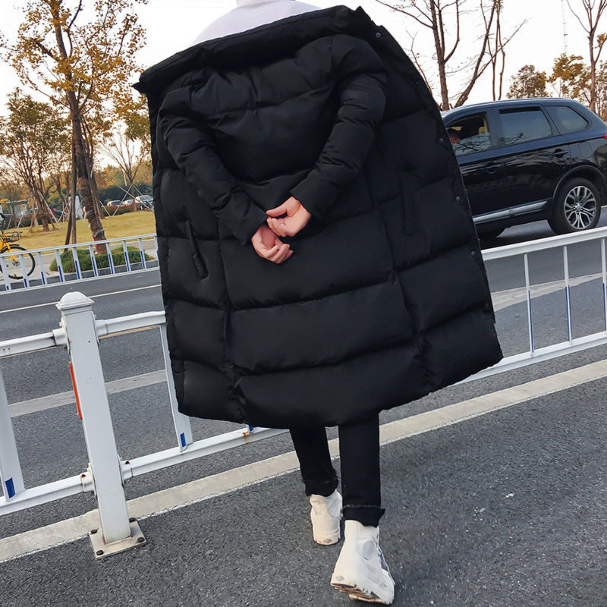 Back view of men’s long winter coat in black.