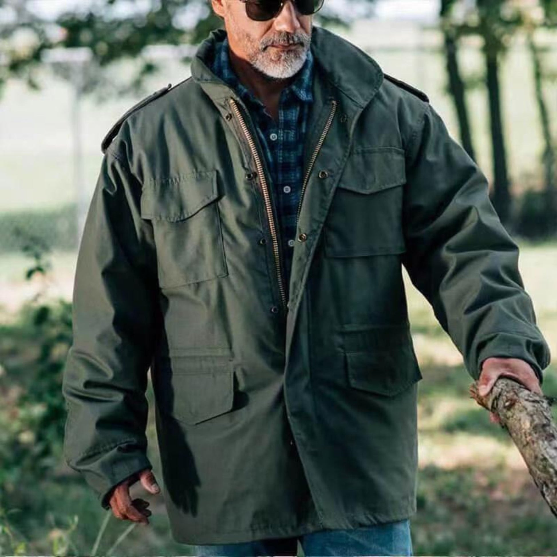 Front view of men's military-style padded coat in classic green with zipper closure.