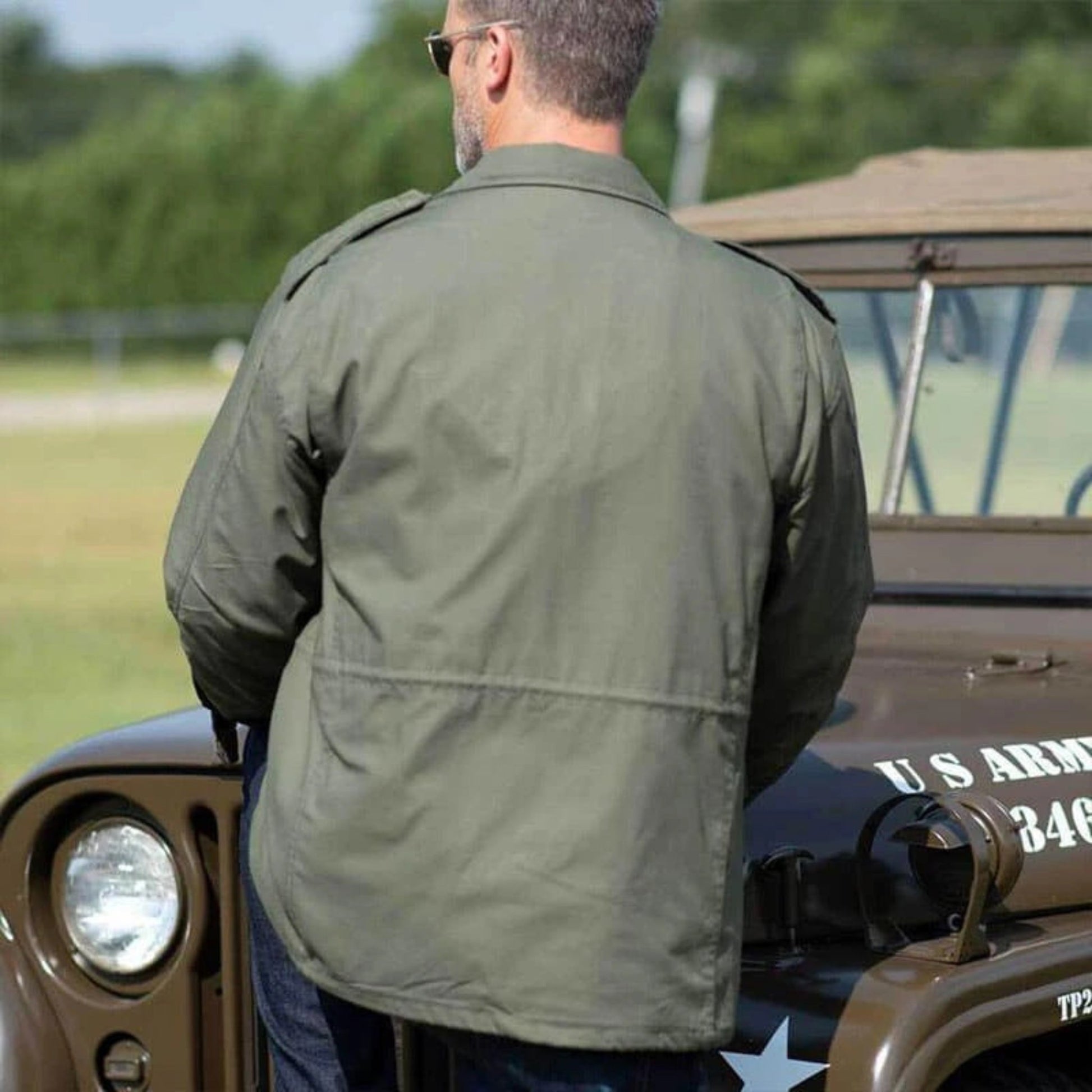 Back view of men's military-style coat showing sleek and durable design.