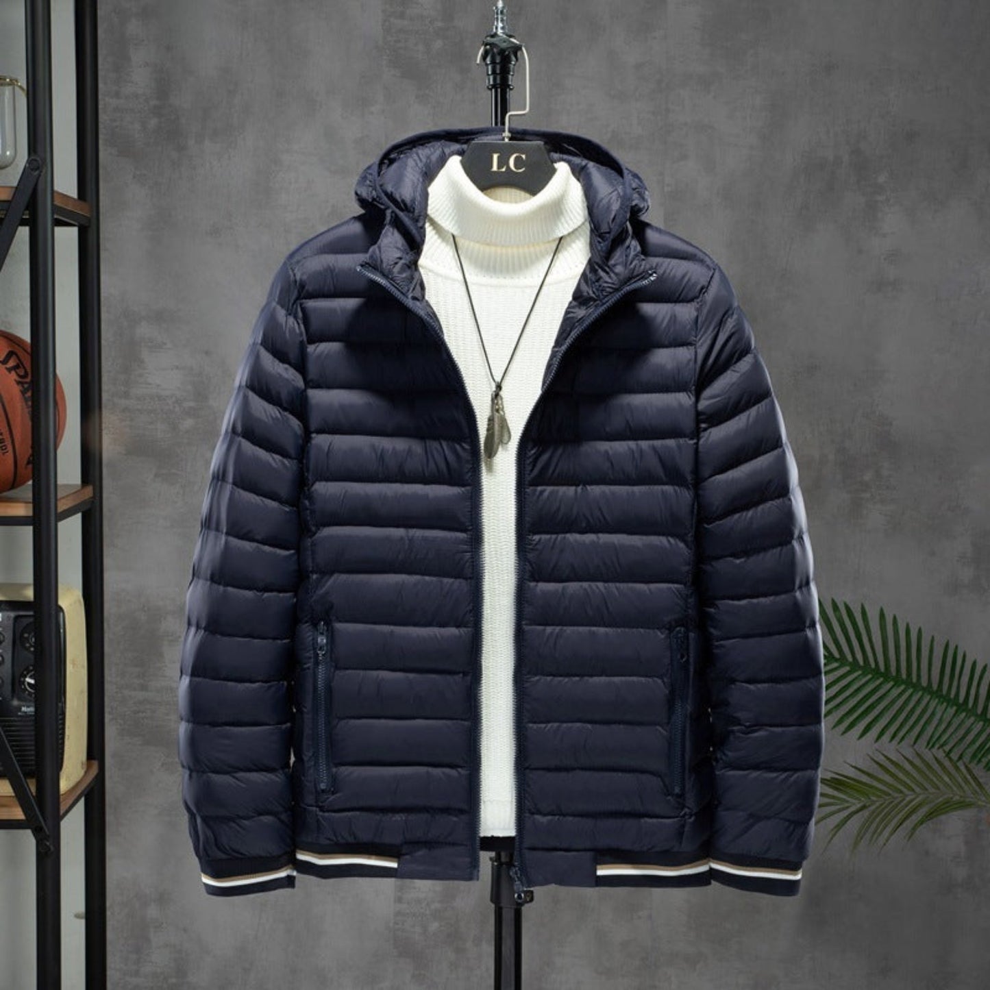 Blue men's cotton-padded jacket with detachable hood and white interior, displayed on a hanger.